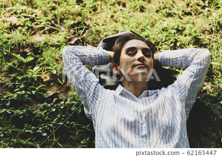 Beautiful woman sleeping relaxation on green grass 62165447
