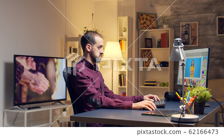 Professional photographer using pad for photo retouching 62166473