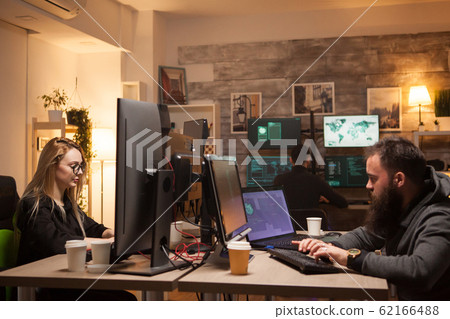 Beautiful female hacker in working together with cyber criminals Beautiful female hacker in working together with cyber criminals 62166488