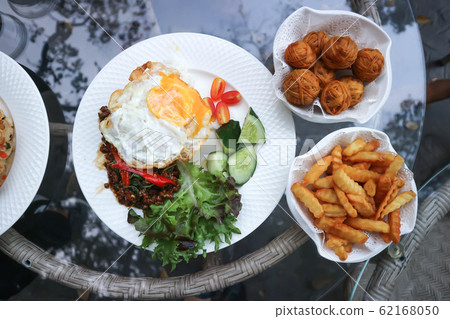 stir fried pork with fried egg, holy basil and stir fried pork with fried egg, holy basil and 62168050