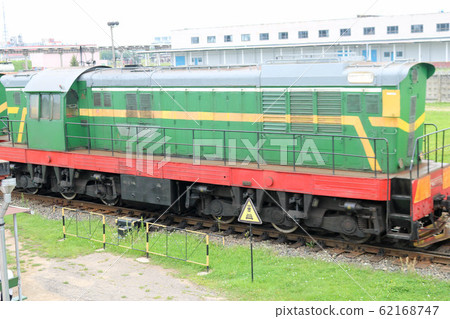 Green metallic iron wheeled freight train 62168747