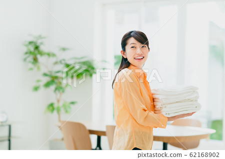 Young woman (laundering) 62168902