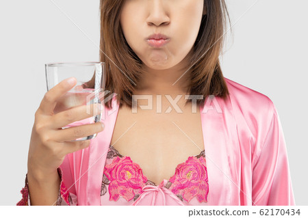 Woman rinsing and gargling after brushing 62170434
