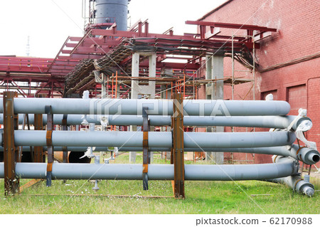 A large iron metal piping trestle with pipes A large iron metal piping trestle with pipes 62170988
