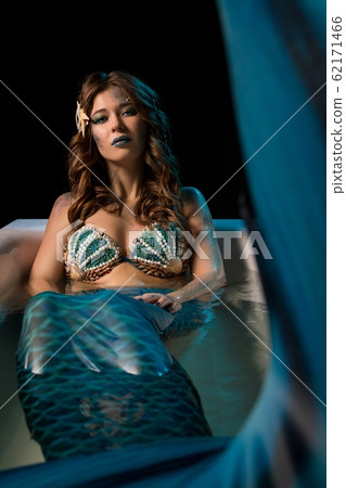 Woman in mermaid image lying in bath view 62171466