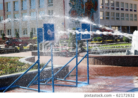 A wet, powerful stream of water splashes A wet, powerful stream of water splashes 62172632