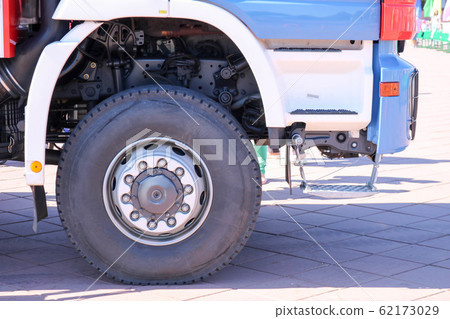 A large black rubber wheel with a truck cover  62173029