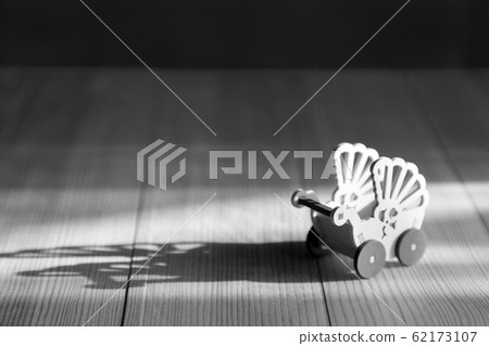 Empty pram on wooden background Empty pram on wooden background 62173107