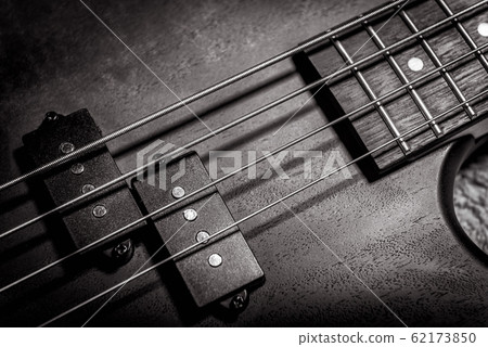 Bass guitar with four strings in black and white 62173850