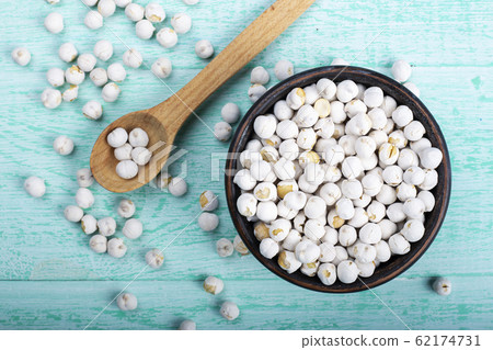 raw dry chickpeas on a wooden background raw dry chickpeas on a wooden background 62174731