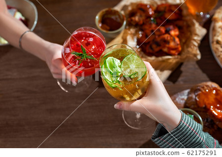 Toast with aperol spritz coctails in hends 62175291