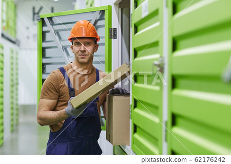 Worker with parcels in warehouse 62176242