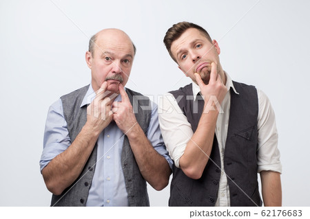 Two mature men father and son being sad. Negative facial emotion 62176683