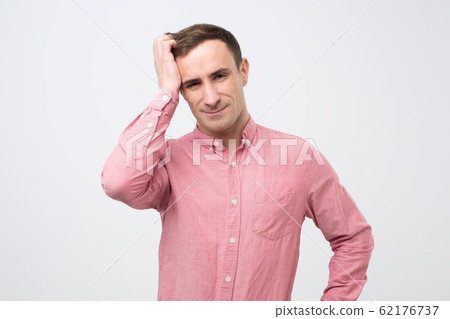 man in pink shirt being shocked, he try to remember important in formation before meeting. 62176737