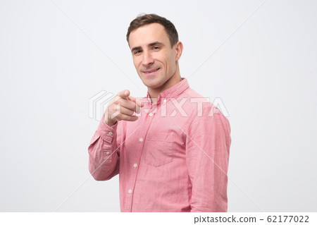 Handsome young man pointing forward choosing you. You are the best fellow. 62177022