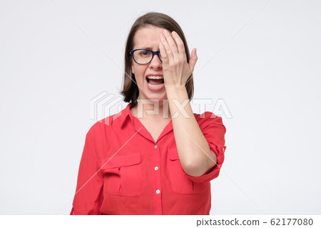 Woman in glasses checking eyesight exam. I need new glasses. 62177080