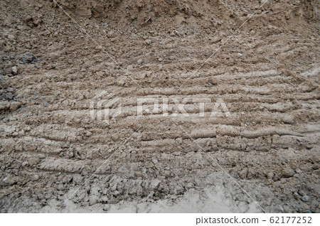 View of brown cracked natural moist earth View of brown cracked natural moist earth 62177252