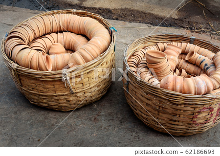 Clay cups in basket on the street. Kolkata. India 62186693
