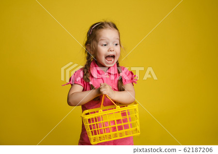 Funny little girl with shopping basket. Isolate on Funny little girl with shopping basket. Isolate on 62187206