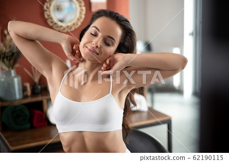 Beautiful young woman is stretching after awake Beautiful young woman is stretching after awake 62190115