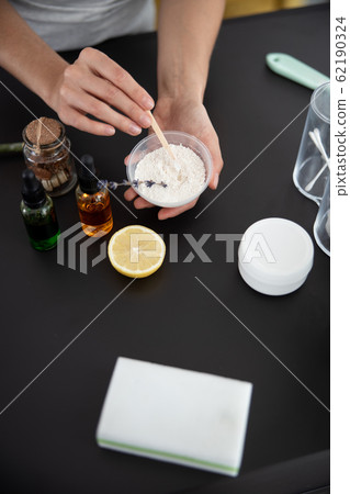 Young lady preparing cosmetic clay for mask 62190324
