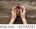 Home-made beet chips. Snacks are wrapped in a paper bag. Hand holds food bag. Handmade healthy vegetables chips 62193281