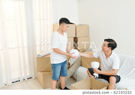 Father and son unpacking belongings 62193282