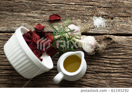 Beetroot Chips. Healthy handmade vegetable chips. In the dishes, pieces of root vegetables. Garlic and oregano spices for the dish. The preparation uses olive oil and salt. Soft focus 62193292