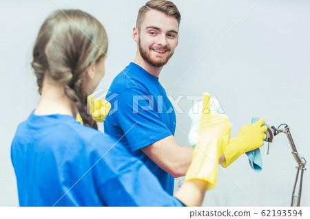 Cleaning squad dusting an office Cleaning squad dusting an office 62193594