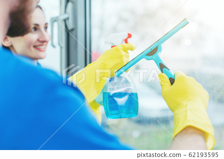Commercial cleaners cleaning an office window Commercial cleaners cleaning an office window 62193595