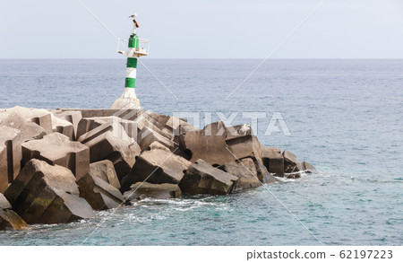 Green and white striped beacon tower 62197223