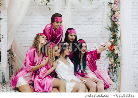 Pretty bridesmaids with bride taking selfie at hen 62198352