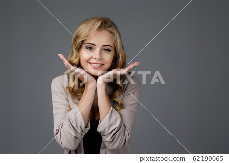 smiling happy young woman looking at camera 62199065