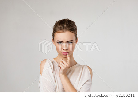 Portrait of cute brunette woman thinking about something 62199211