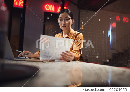 Young Asian Woman Working in Dark 62201053