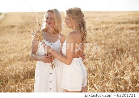 Mother with beautiful daughter in a autumn field 62201721