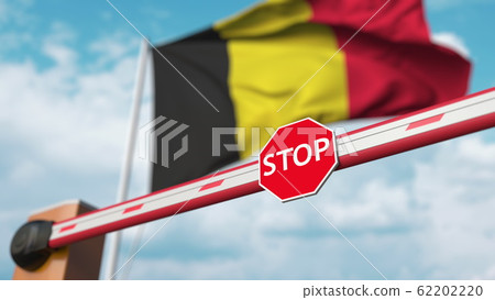 Barrier gate being closed with flag of Belgium as a background. Belgian restricted entry or certain ban. 3D rendering Barrier gate being closed with flag of Belgium as a background. Belgian restricted entry or certain ban. 3D rendering 62202220