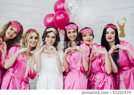 Lovely bridesmaids in pink robes and sleep masks Lovely bridesmaids in pink robes and sleep masks 62202479