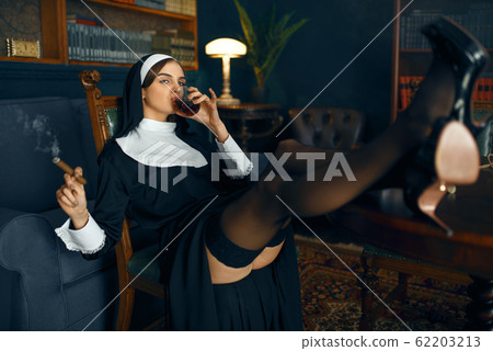 Nun sitting in a depraved pose, attractive sinner 62203213