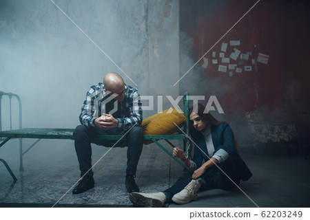 Maniac kidnapper and victim handcuffed to the bed Maniac kidnapper and victim handcuffed to the bed 62203249