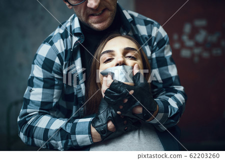 Maniac kidnapper tormenting his scared victim 62203260