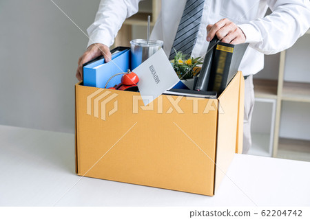 Images of businessman carrying packing up all his 62204742