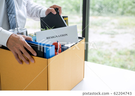 Images of businessman carrying packing up all his 62204743