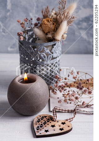 lit candle and wooden heart lit candle and wooden heart 62205294