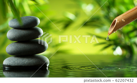 A stream of water flowing out of bamboo tube A stream of water flowing out of bamboo tube 62207432