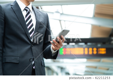 Commuter Men Train Station Businessmen Smartphone Photo shooting cooperation: Keio Electric Railway Co., Ltd. 62211253