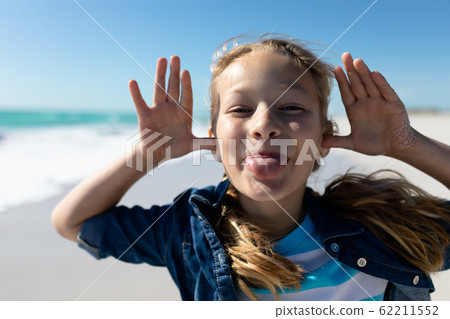 Girl playing at the beach 62211552
