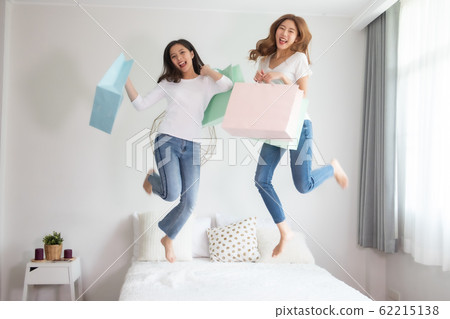 Cheerful happy Asian woman enjoying shopping Cheerful happy Asian woman enjoying shopping 62215138