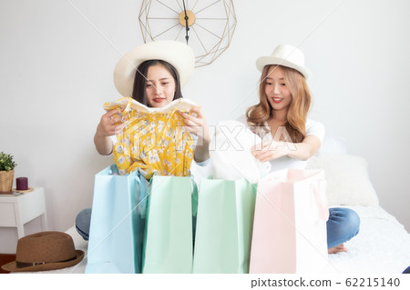 Cheerful happy Asian woman enjoying shopping Cheerful happy Asian woman enjoying shopping 62215140