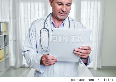 Doctor reading medical history Doctor reading medical history 62217124
